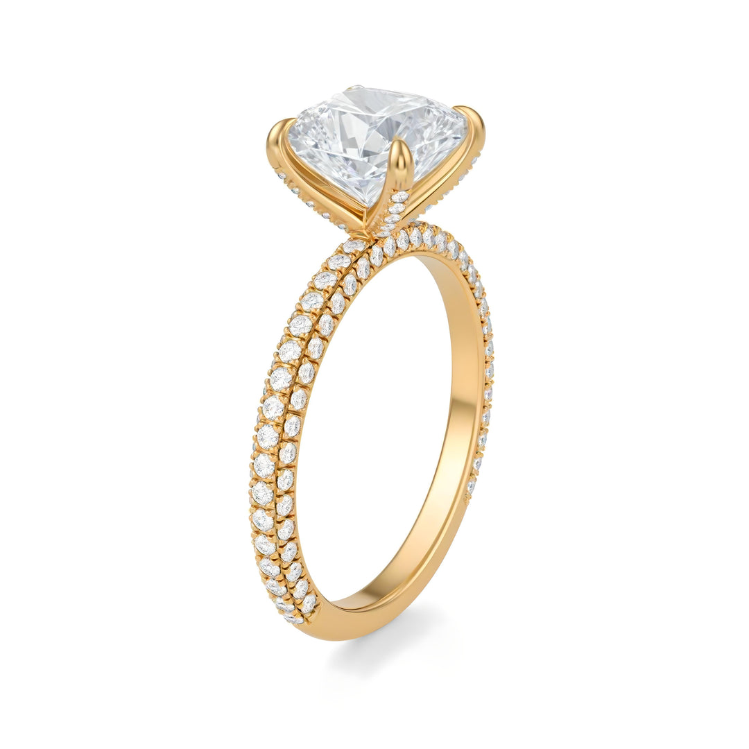 Gold ring with a large diamond and smaller diamonds on the band against a white background