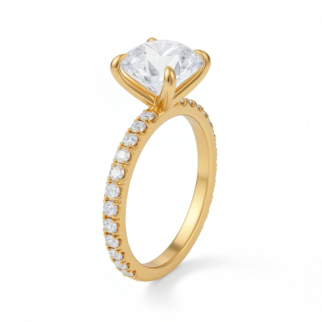 Gold ring with a large diamond and smaller diamonds on the band against a white background
