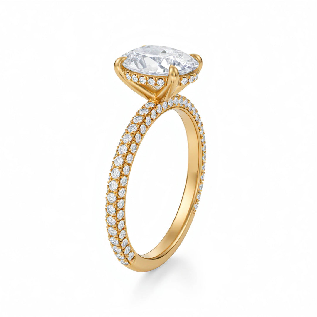 Gold ring with a large diamond and smaller diamonds on the band against a white background