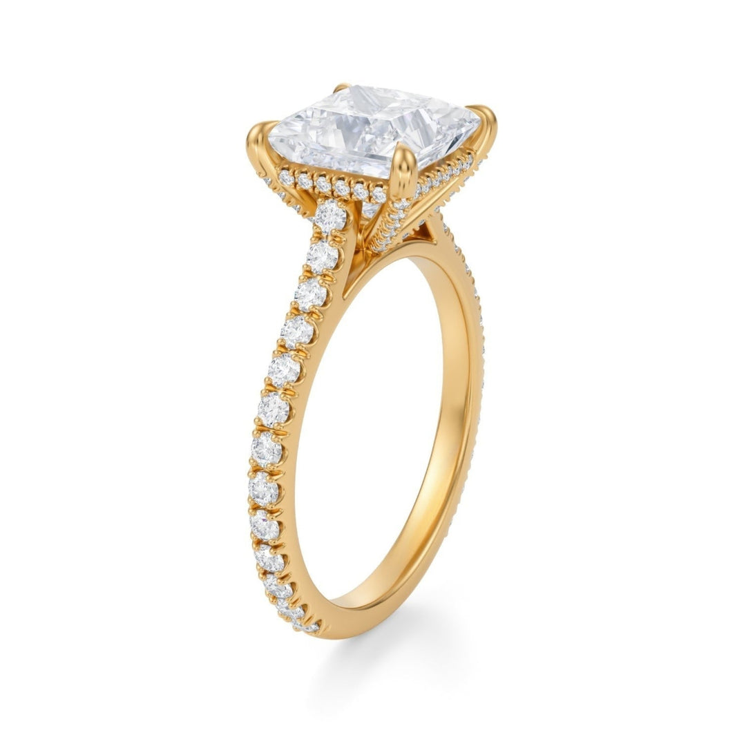 A princess pave cathedral ring with a pave basket, featuring a large center diamond surrounded by smaller diamonds on the band, set against a white background.