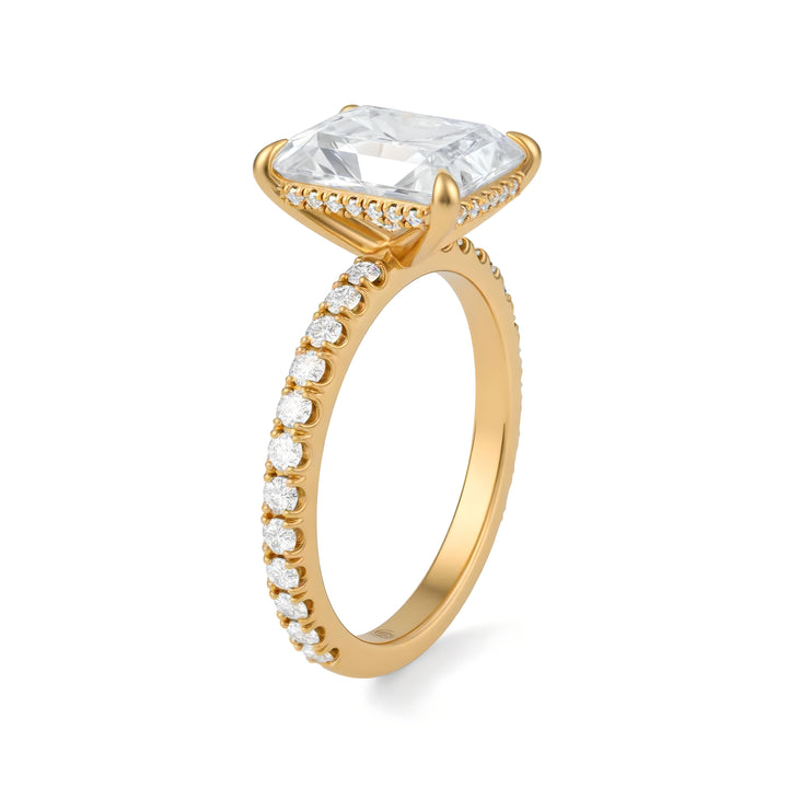 Gold ring with a large central diamond and smaller diamonds along the band on a white background