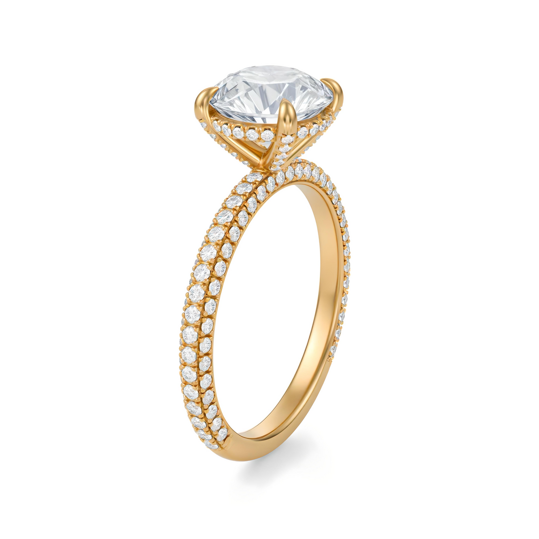 Gold ring with a large diamond and smaller diamonds on the band against a white background