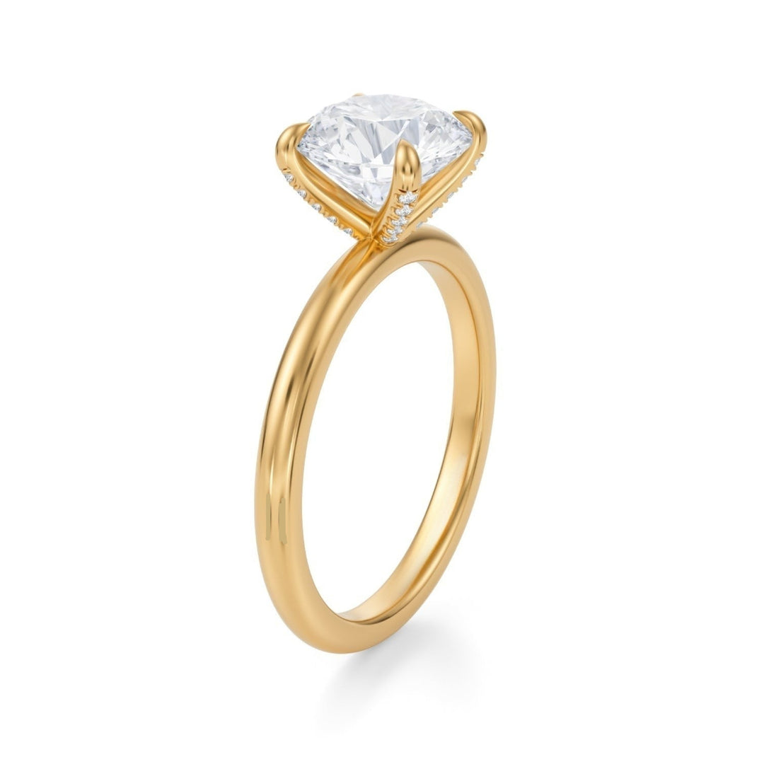 A single round solitaire diamond ring with pave prongs on a white background, showcasing the ring's detailed craftsmanship and the sparkling diamond.