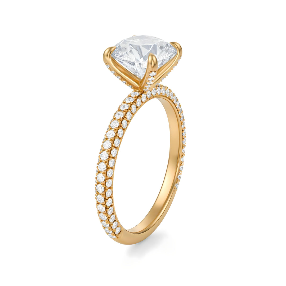 Gold ring with a large diamond and smaller diamonds on the band against a white background