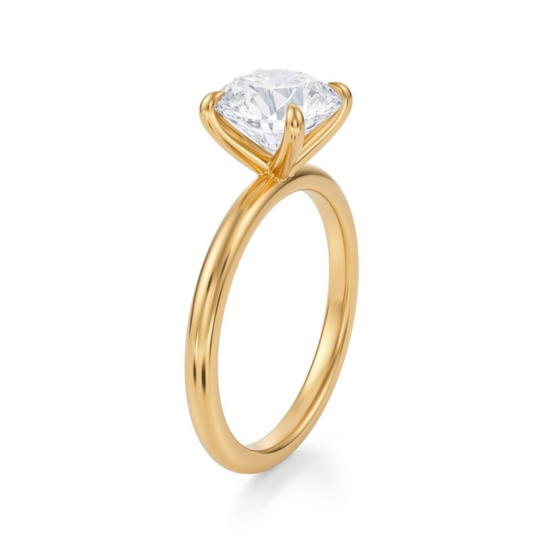 A classic round solitaire ring with a single diamond on a minimalist band.