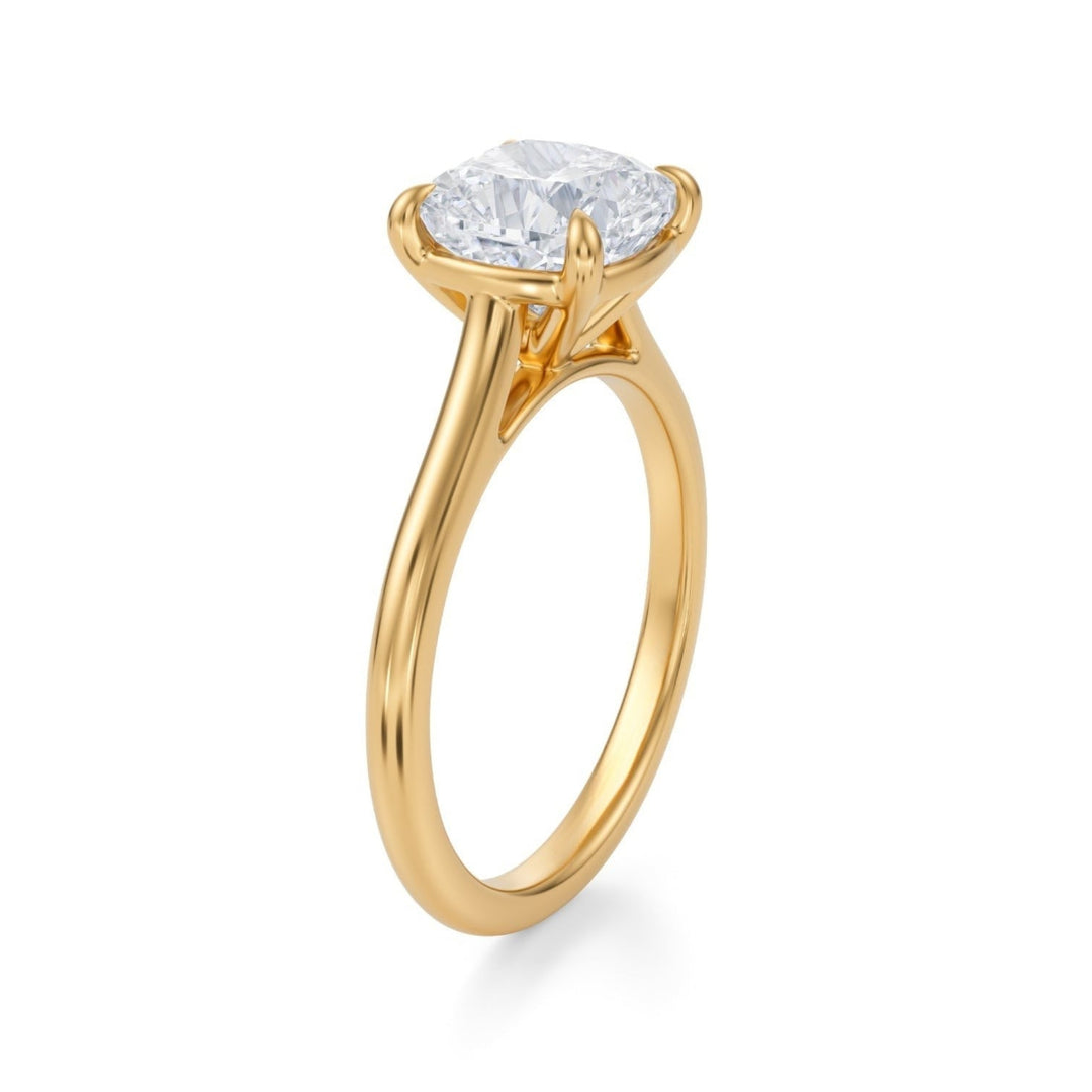 A cushion cut diamond ring with a cathedral setting, displayed on a white background.