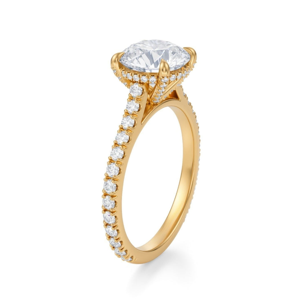 A silver ring featuring a round-cut diamond in a cathedral setting with a pave band