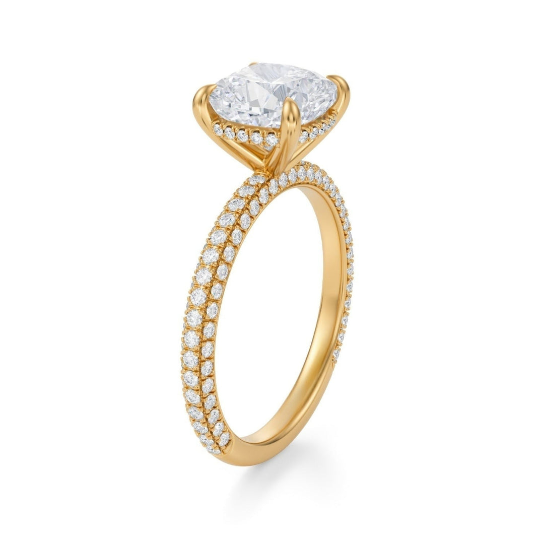 A cushion-cut diamond ring with a halo and pave band, set in a white gold or silver metal.