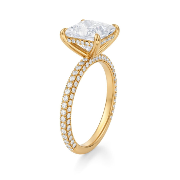 A princess-cut diamond ring with a halo and pave band, set in a mounting, with a white background.