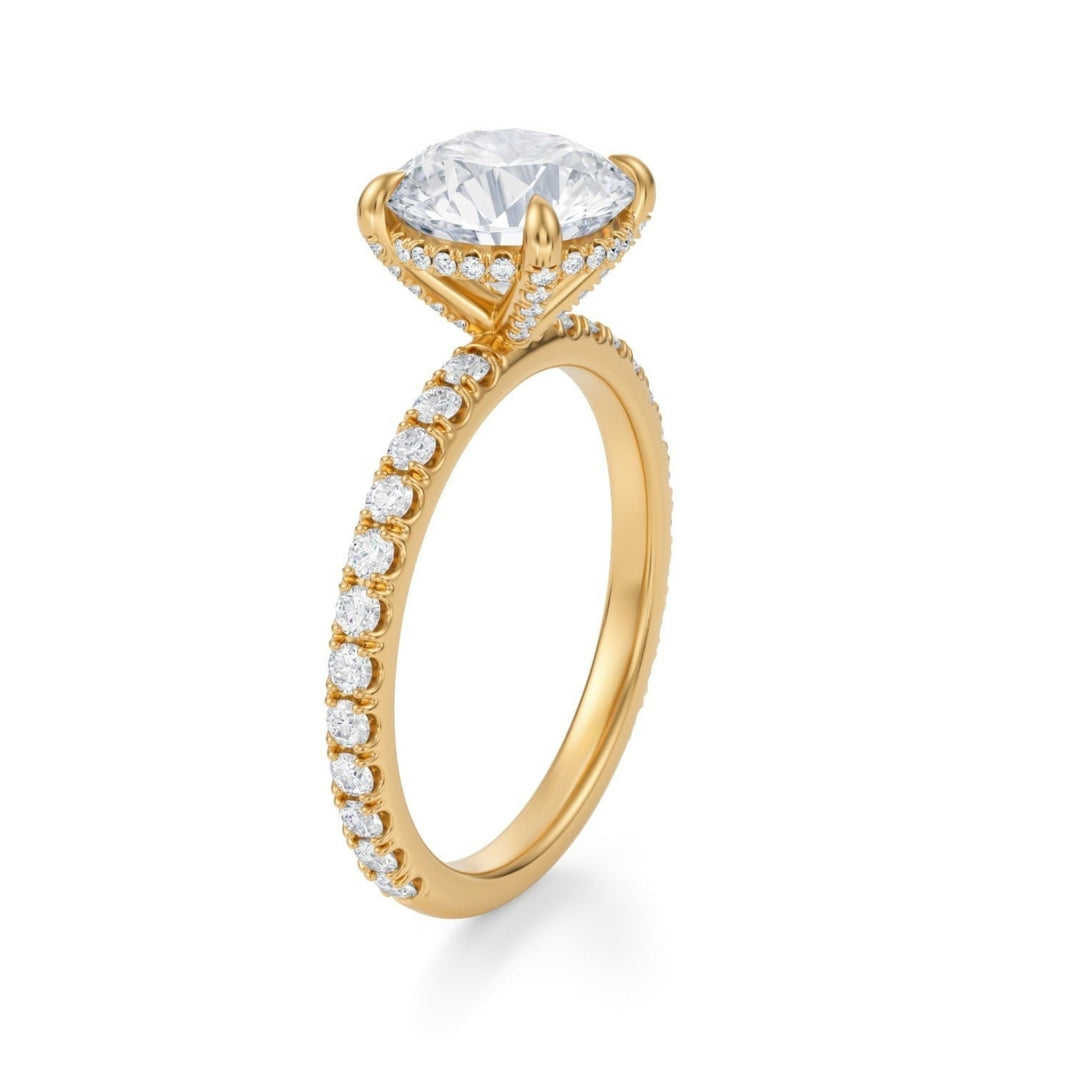 A round-cut diamond ring with a pave band, set in a metal basket, likely platinum or white gold.