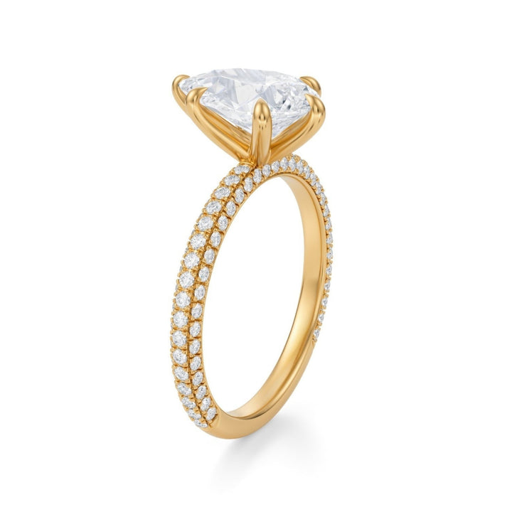 A silver ring with a central pear-shaped diamond surrounded by smaller diamonds on the band, set against a white background.