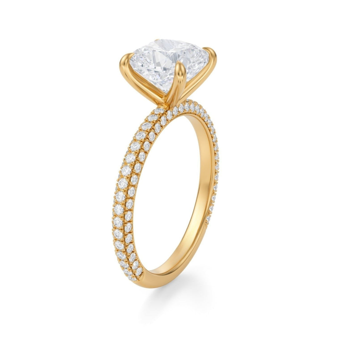 A cushion cut lab-created diamond ring with a pave band, set against a white background.