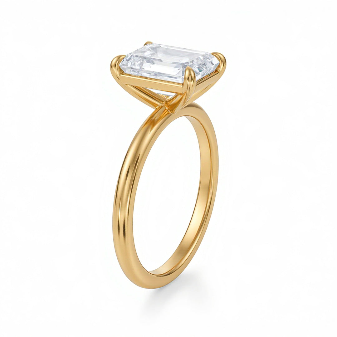 Gold ring with a rectangular diamond on a white background