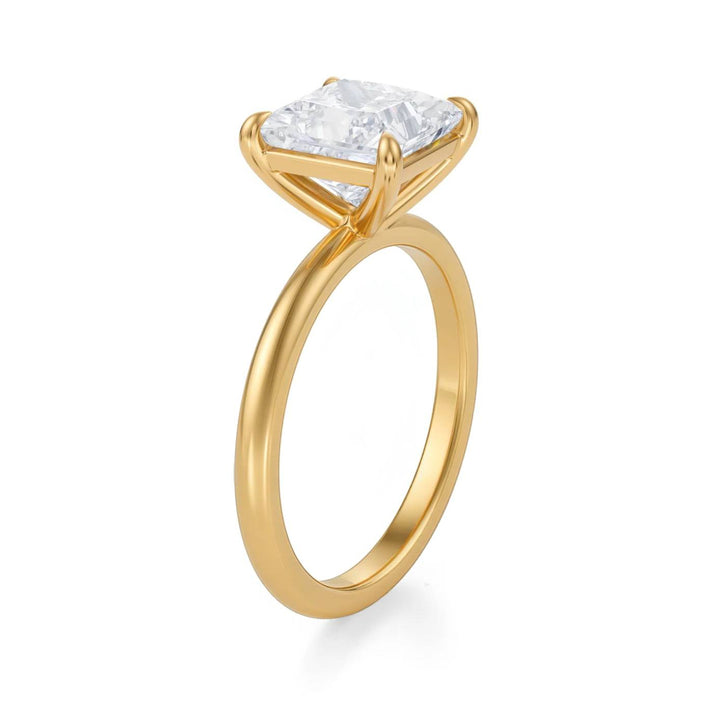 Gold ring with a large diamond on a white background