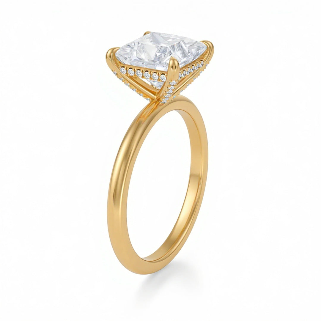 Gold ring with a large diamond and smaller diamonds on the band against a white background