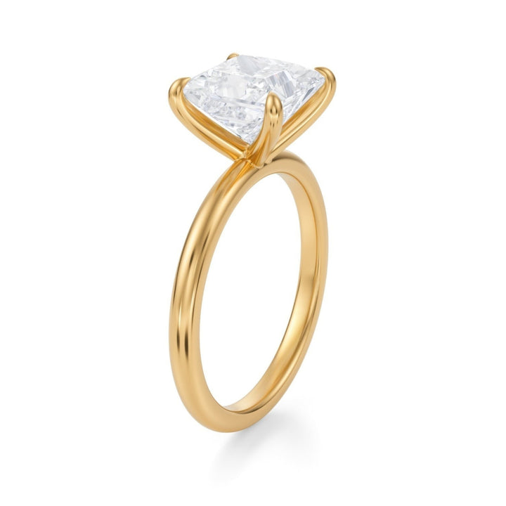 A princess cut diamond ring set on a minimalistic band, displayed against a white background.