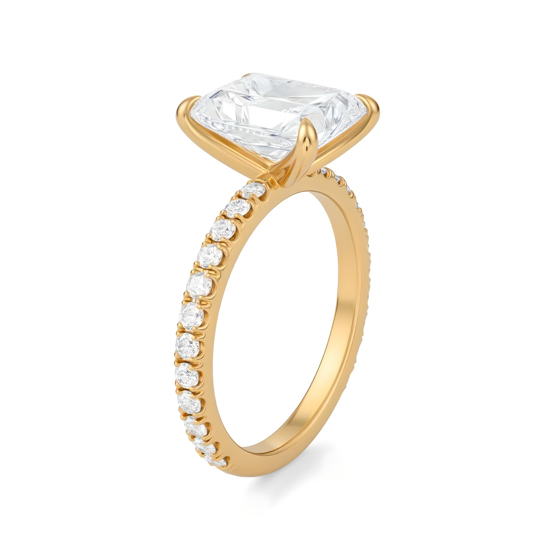 Gold ring with a large diamond and smaller diamonds on the band against a white background