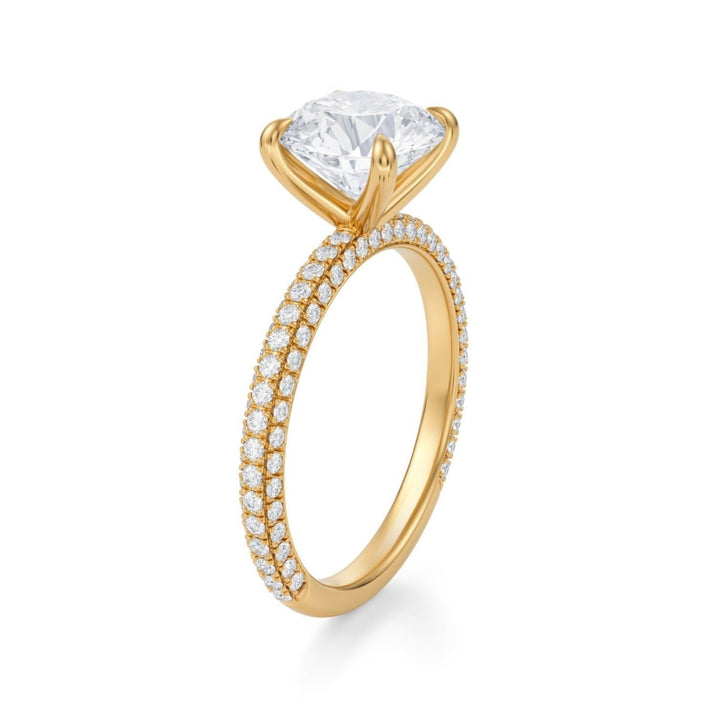 A silver ring with a round central diamond surrounded by a pave of smaller diamonds, set against a white background.
