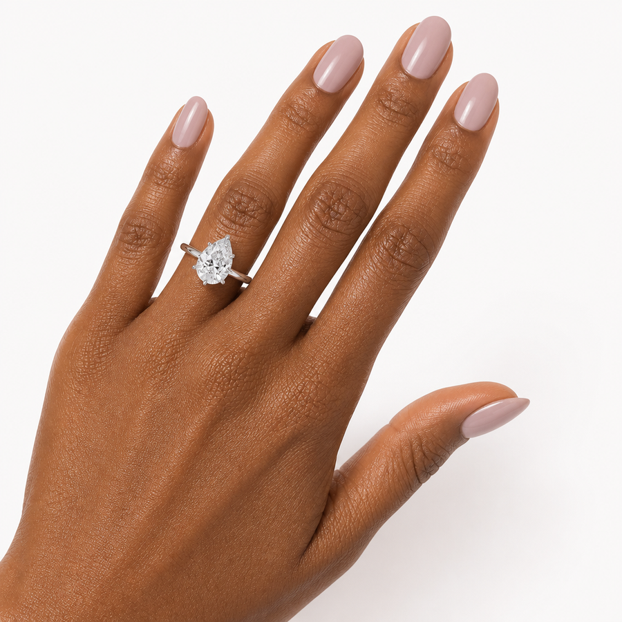 Pear Solitaire Ring With Diamond Basket