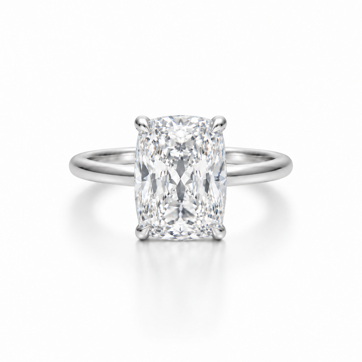 Elongated cushion-cut diamond solitaire ring in platinum with a slim cathedral band, photographed straight-on against a white background.