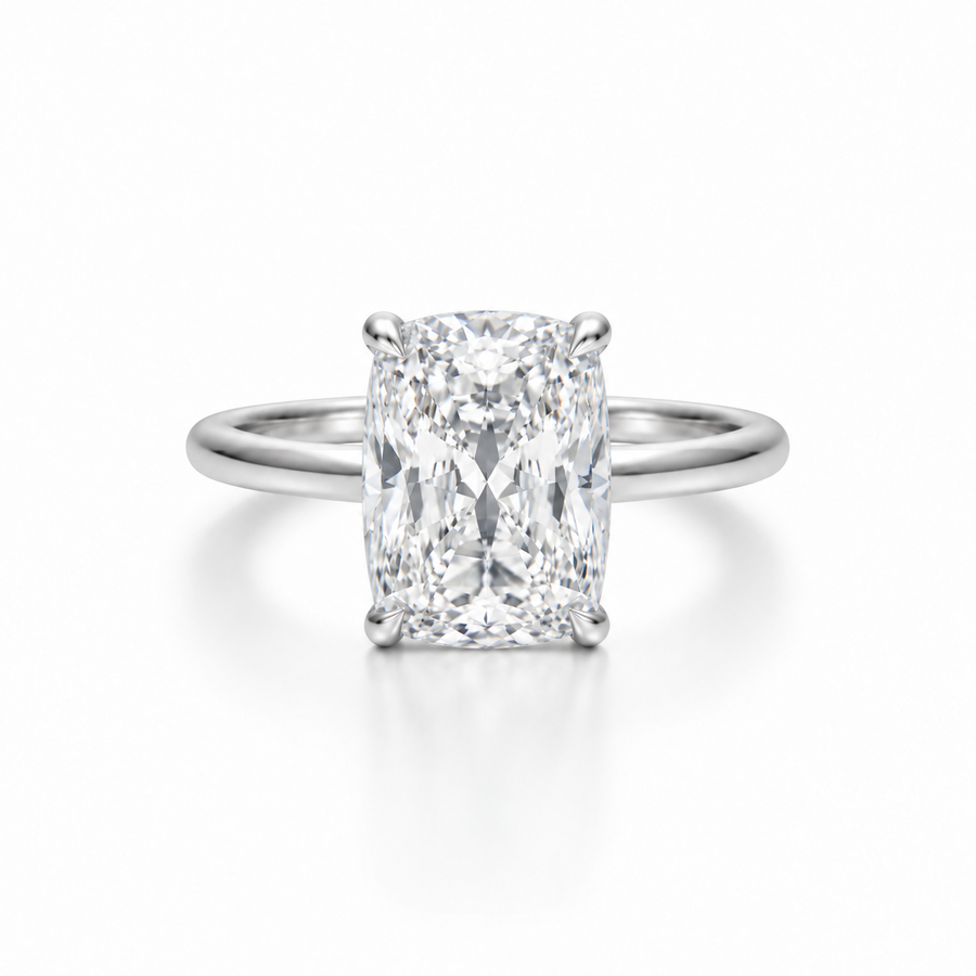 Elongated cushion-cut diamond solitaire ring in platinum with a slim cathedral band, photographed straight-on against a white background.