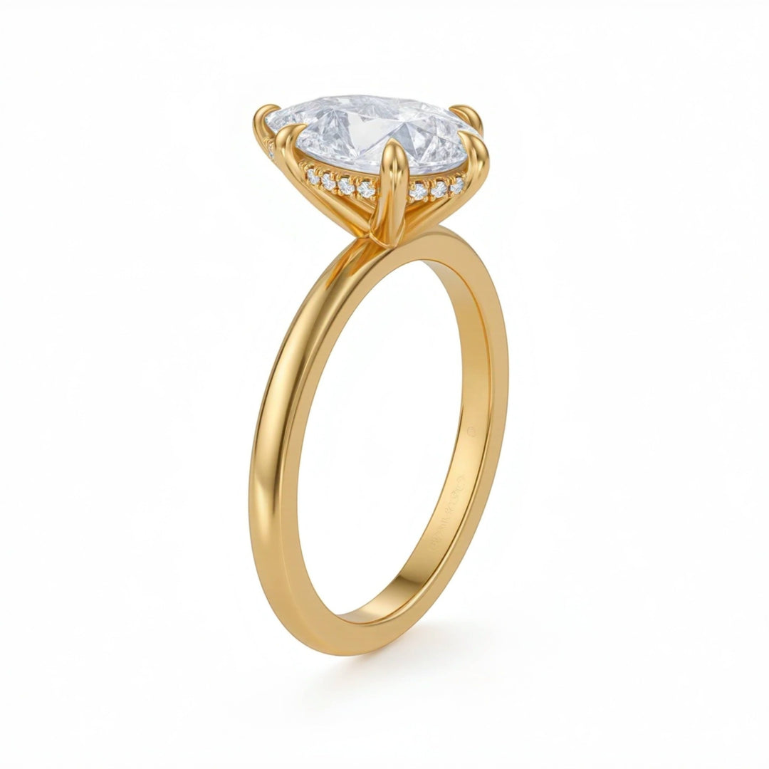 Gold ring with a large diamond and smaller diamonds on the band against a white background