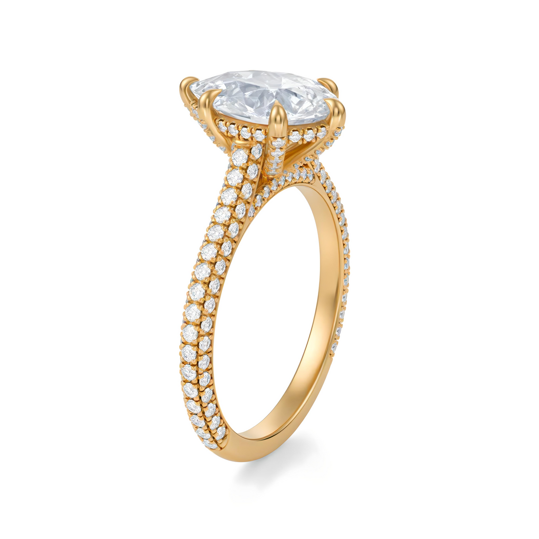 Gold ring with a large diamond and smaller diamonds on the band against a white background