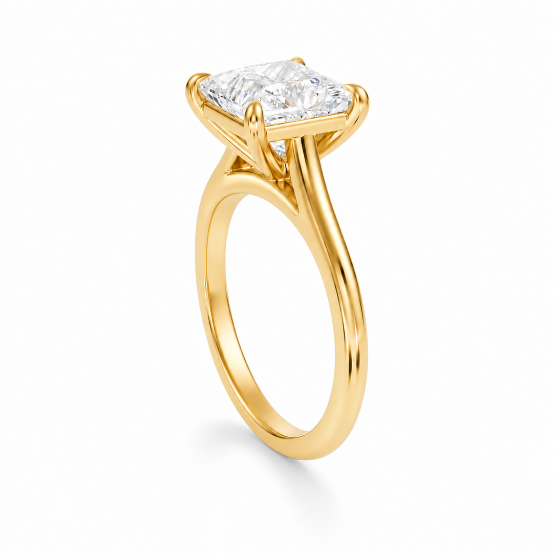Princess cut diamond solitaire engagement ring in yellow gold with cathedral setting, shown at a side angle on white background.